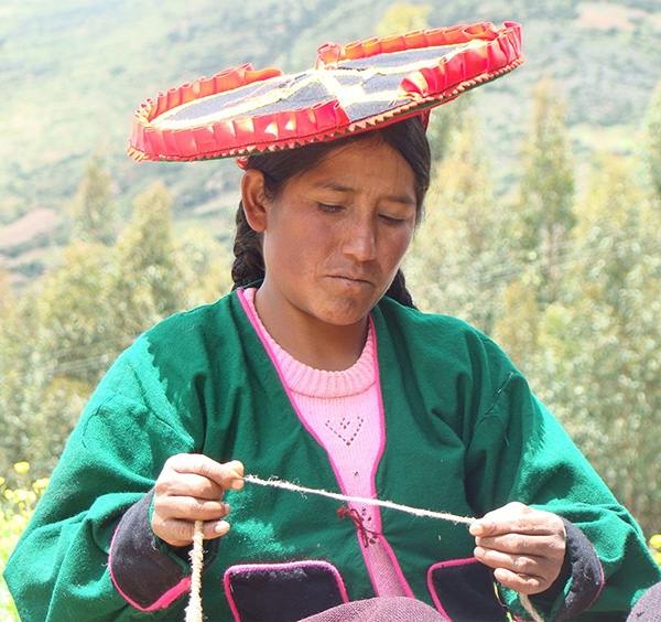 Photograph of a woman weaving in Peru